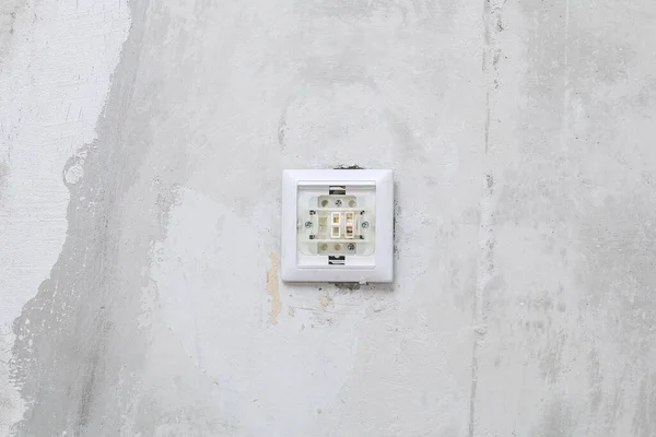 Um trabalhador remove interruptor de luz para papel de parede. — Fotografia de Stock