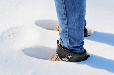 Karda yürüyen bir adam, karda ayak izleri, derin kar, kar yağışı.