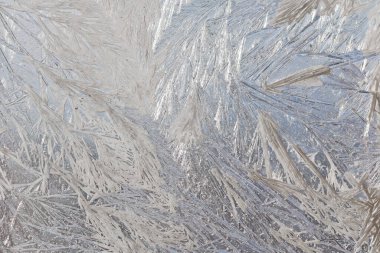 Cam pencerede karlı ve soğuk desenler var. Kış büyüsü. Buz gibi harikalar..