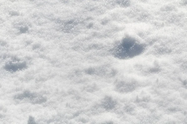 Vintersnö. Snö struktur Ovanifrån av snön. Konsistensdesign. Snövit konsistens. Snöflingor. — Stockfoto