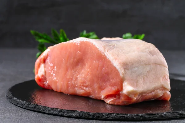 Raw pork loin. Pork meat on table.
