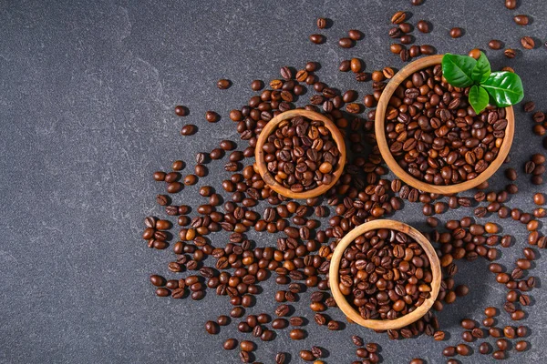 Granos de café tostados sobre un fondo gris. —  Fotos de Stock