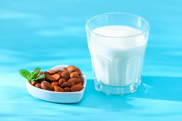 Almond milk with almond kernels. Alternative milk for vegetarians.