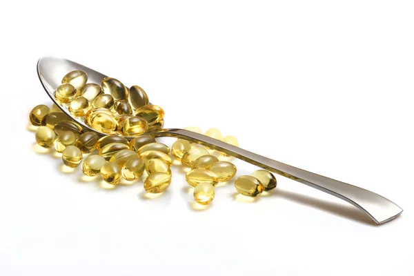 Kaşık sağlıklı vitamin kapsül tam. Beyaz izole