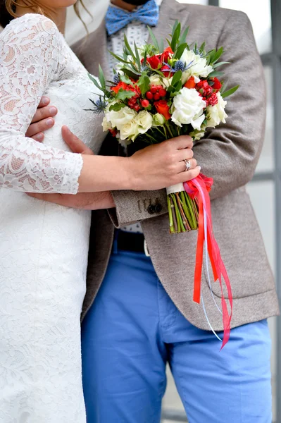 Beautiful wedding bouquet of pink and white peony flowers in hands of the bride — Stock Photo, Image