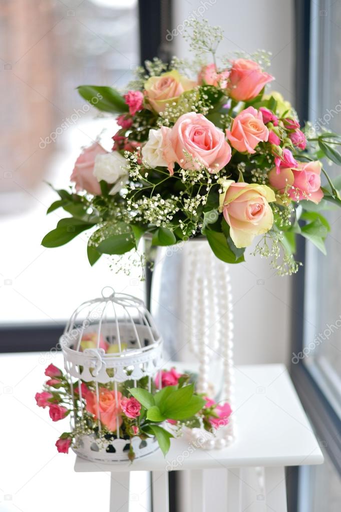bridal bouquet standing in a vase wrapped in pearls