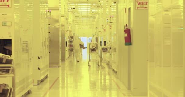 Trabajadores con trajes limpios en una instalación de fabricación de semiconductores — Vídeos de Stock