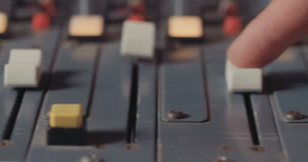 Sound engineer working with a mixing console in a recording studio — Stock Video