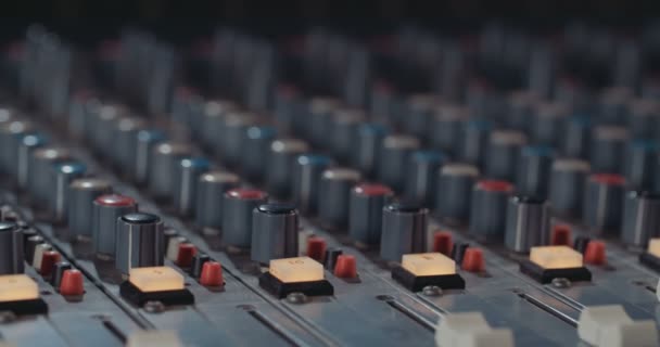 Sound engineer working with a mixing console in a recording studio — Stock Video