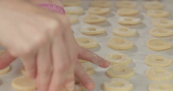 Baker making holes in butter cookies — Stock Video