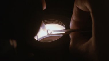 Bir gemologist büyük 3 karat elmas mikroskopla inceleme