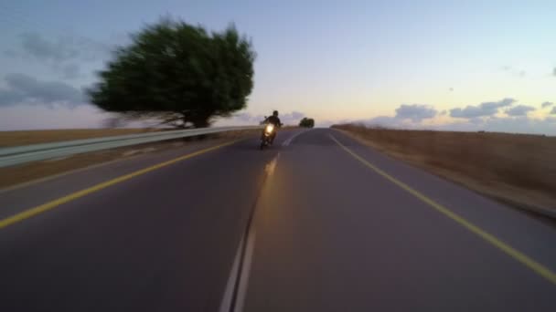 Sports motorcycle driving down a curved countryside road — Stock Video