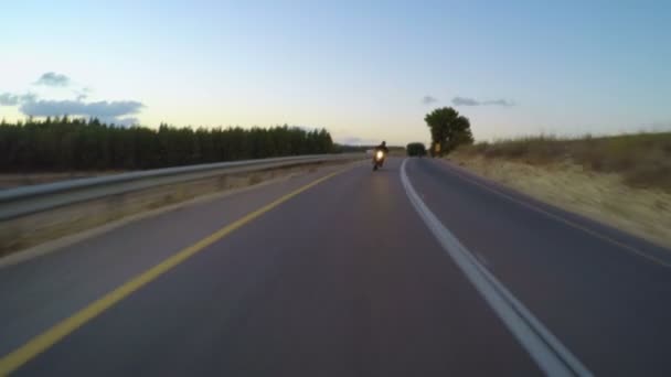 Sports motorcycle driving down a curved countryside road — Stock Video