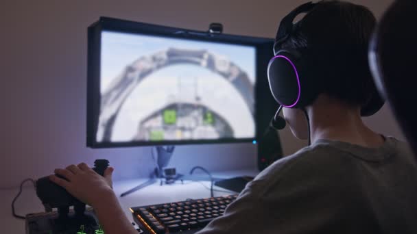 Niño jugando un simulador de vuelo con auriculares — Vídeos de Stock
