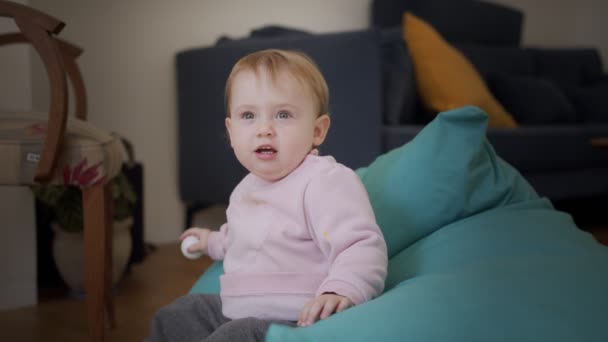 Cute baby girl playing at home and smiling to the camera — Stock Video