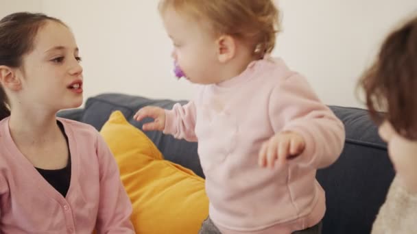 Baby girl playing with 2 young girls, laughing and smiling — Stock Video