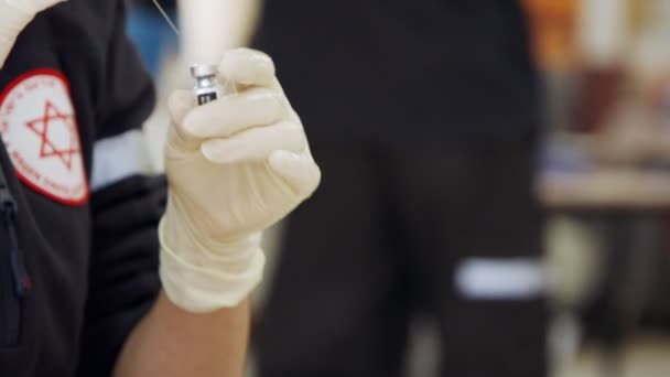 Διασώστης που χορηγεί στους ανθρώπους την ένεση του εμβολίου COVID- 19 κατά τη διάρκεια της επέμβασης εμβολιασμού — Αρχείο Βίντεο