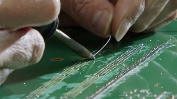 Manual soldering of electronic components on a PCB board, close up — Stock Video