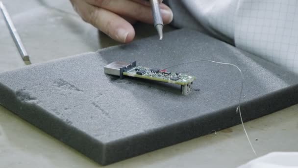 PCB panosundaki elektronik bileşenlerin elle lehimlenmesi. — Stok video