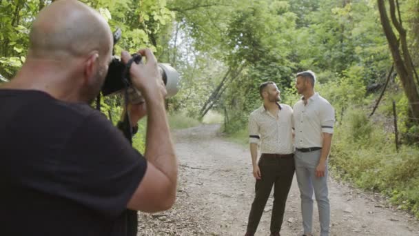 Photographer taking pictures of gay couple before their wedding — Stock Video