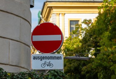 No entry sign with bicycle exception on urban european street.