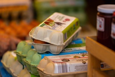 Klagenfurt, Austria - October 04, 2025: Organic eggs displayed in colorful cartons at local market during Erntedankfest, highlighting festive atmosphere and community spirit