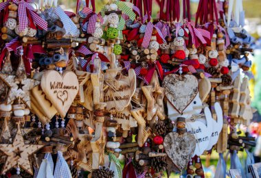 Charming wooden ornaments and decorations with heart and star designs.