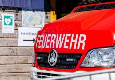 St Veit An Der Glan, Austria - October 03, 2025: Red fire vehicle with Feuerwehr branding is stationed at St. Veiter Wiesenmarkt, highlighting local emergency response
