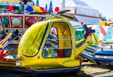 St Veit An Der Glan, Austria - October 03, 2025: Amusement park helicopter ride at St. Veiter Wiesenmarkt, featuring bright colors and inviting design for children