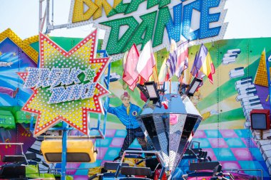 St Veit An Der Glan, Austria - October 03, 2025: Break Dance amusement ride at St. Veiter Wiesenmarkt, adorned with bright colors and flags, inviting excitement and joy