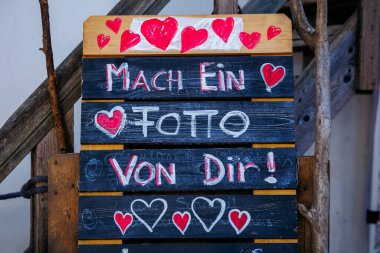 St Veit An Der Glan, Austria - October 03, 2025: Colorful sign with hearts encourages visitors to capture memories at St. Veiter Wiesenmarkt, enhancing festive spirit