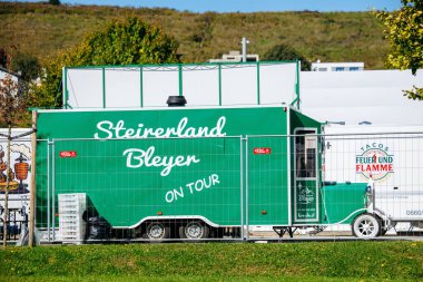 St Veit An Der Glan, Austria - October 03, 2025: Food truck Steirerland Bleyer is parked at St. Veiter Wiesenmarkt, featuring a lively green design and inviting ambiance