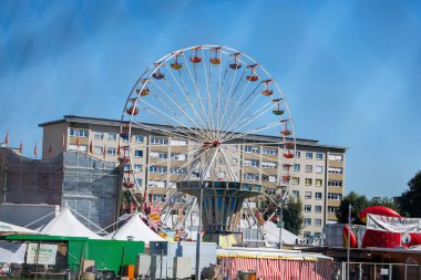 St Veit An Der Glan, Austria - October 03, 2025: St. Veiter Wiesenmarkt displays a colorful Ferris wheel with surrounding tents and buildings, capturing the lively fair ambiance