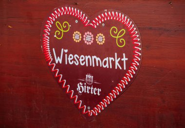 St Veit An Der Glan, Austria - October 03, 2025: Heart-shaped sign reads Wiesenmarkt, adorned with colorful patterns, reflecting the joyful atmosphere of St. Veiter Wiesenmarkt