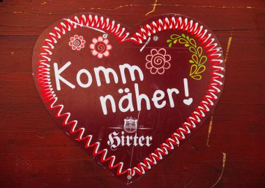 St Veit An Der Glan, Austria - October 03, 2025: Heart-shaped sign with vibrant colors and inviting text 