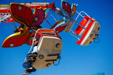 St Veit An Der Glan, Austria - October 03, 2025: Butterfly-themed ride at St. Veiter Wiesenmarkt, capturing the joy and thrill of amusement park attractions