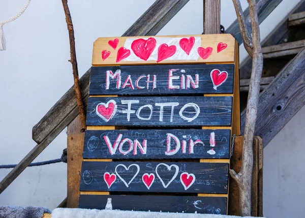 St Veit An Der Glan, Austria - October 03, 2025: Colorful sign with hearts encourages visitors to take a photo at St. Veiter Wiesenmarkt, enhancing festive ambiance