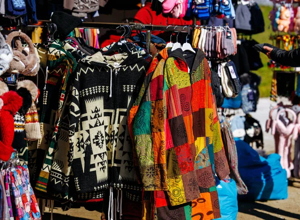 St Veit An Der Glan, Austria - October 03, 2025: Handmade jackets with unique patterns are prominently displayed at St. Veiter Wiesenmarkt, creating a vibrant market scene