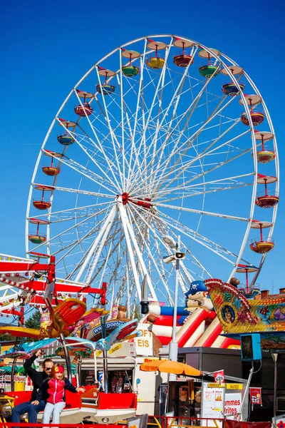 St Veit An Der Glan, Austria - October 03, 2025: St. Veiter Wiesenmarkt showcases a large Ferris wheel and lively carnival rides, creating a cheerful ambiance for visitors