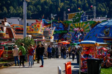 St Veit An Der Glan, Austria - October 03, 2025: Vibrant St. Veiter Wiesenmarkt fairground filled with colorful rides, lively visitors, and festive decorations creating a joyful ambiance