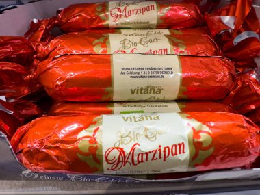 Villach, Austria - October 09, 2025: Marzipan sweets in bright red wrappers highlight organic ingredients and premium quality, ideal for chocolate enthusiasts