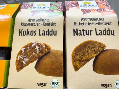 Villach, Austria - October 09, 2025: Vegan Ayurvedic chickpea sweets in attractive packaging, featuring Kokos Laddu and Natur Laddu, perfect for health-conscious consumers