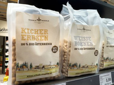 Villach, Austria - October 09, 2025: Organic chickpeas and white beans in eco-friendly packaging on supermarket shelf, promoting healthy eating and sustainability