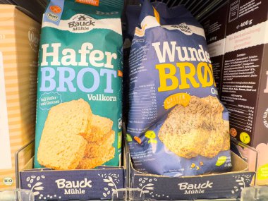 Villach, Austria - October 09, 2025: Baueck Muehle's Haferbrot and Wunderbrot are prominently displayed on a supermarket shelf, highlighting organic bread options
