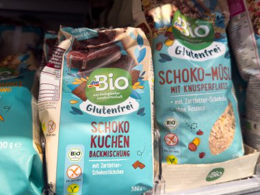 Villach, Austria - October 09, 2025: dmBio gluten-free baking mixes are showcased on a supermarket shelf, highlighting chocolate cake and muesli products