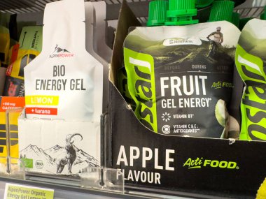Villach, Austria - October 09, 2025: AlpenPower Bio Energy Gel and Ostat Fruit Gel Energy on a shelf, highlighting colorful packaging and nutritious energy choices for active lifestyles
