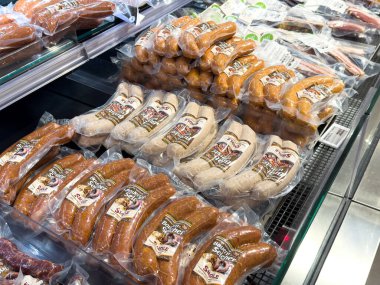Villach, Austria - October 09, 2025: Packaged sausages in a supermarket display, featuring different flavors and types for food lovers and shoppers