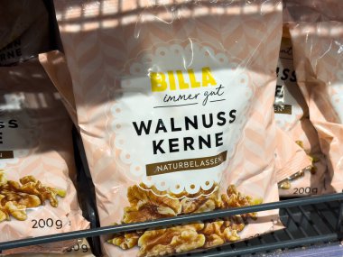 Villach, Austria - October 09, 2025: BILLA walnut kernels in pink packaging are neatly arranged on a supermarket shelf, highlighting healthy snack choices