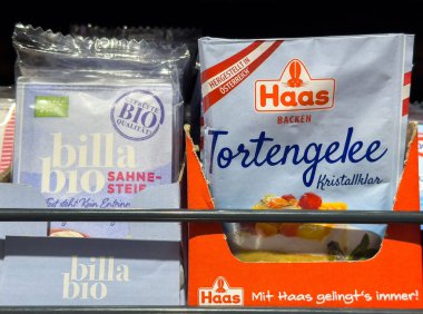 Villach, Austria - October 09, 2025: Billa Bio Sahne-Steif and Haas Tortengelee packaging on store shelf, highlighting organic ingredients and dessert options
