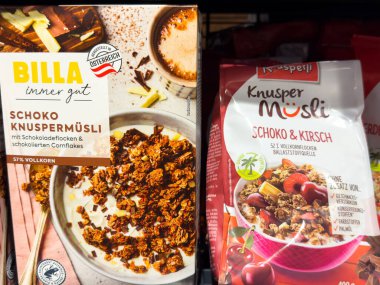 Villach, Austria - October 09, 2025: BILLA Schoko Knuspermusli and Krspejl Schoko & Kirsch cereal boxes are arranged on a shelf, highlighting tasty breakfast choices